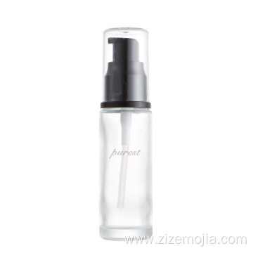 Empty round glass lotion bottle with pump